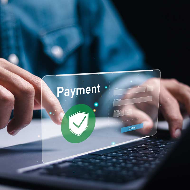 Escudo de pago cibernético con seguridad brillando frente a una laptop.